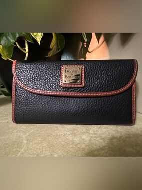 Dooney & Bourke Black Pebbled Leather Wallet with Brown Trim and Gold Plaque